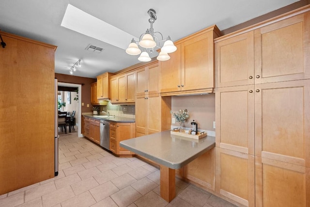 kitchen featuring pendant lighting, visible vents, a sink, a chandelier, and dishwasher