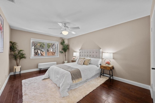 bedroom featuring visible vents, a ceiling fan, hardwood / wood-style flooring, and baseboards