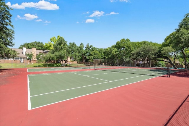 view of sport court featuring fence