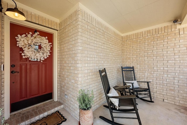 view of exterior entry with a porch