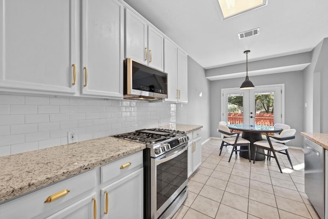 kitchen featuring light tile patterned floors, tasteful backsplash, visible vents, appliances with stainless steel finishes, and white cabinetry