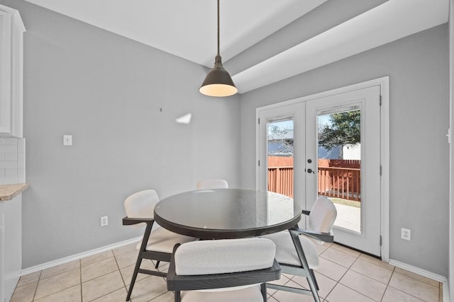 dining space featuring french doors, baseboards, and light tile patterned floors