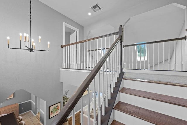 stairway featuring an inviting chandelier, baseboards, visible vents, and recessed lighting