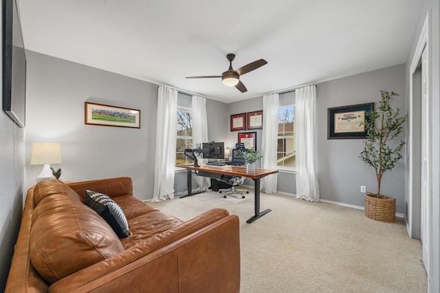 office with ceiling fan, baseboards, and light colored carpet