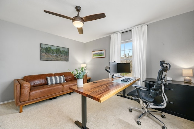 office space featuring carpet floors, ceiling fan, and baseboards