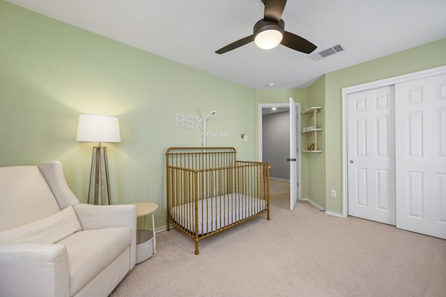 carpeted bedroom featuring a ceiling fan, baseboards, visible vents, and a closet