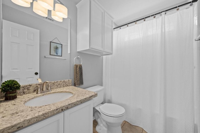 bathroom with visible vents, vanity, toilet, and tile patterned floors