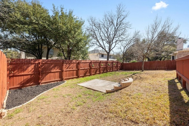 view of yard featuring a patio area and a fenced backyard