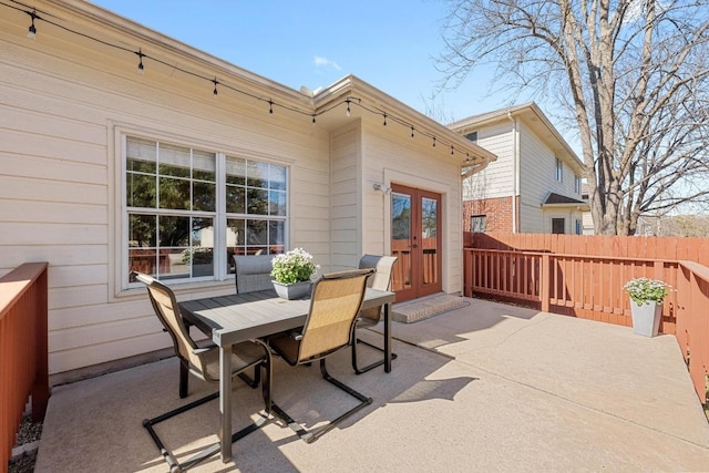 view of patio / terrace with french doors, fence, and outdoor dining area