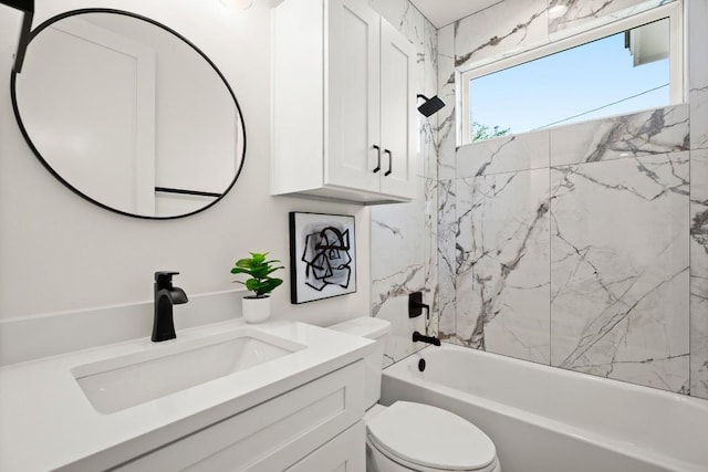 bathroom featuring toilet, shower / washtub combination, and vanity