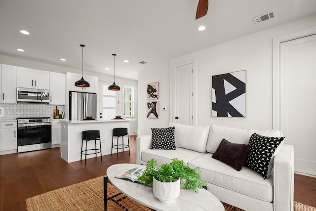 living area featuring dark wood-style floors, recessed lighting, and a ceiling fan