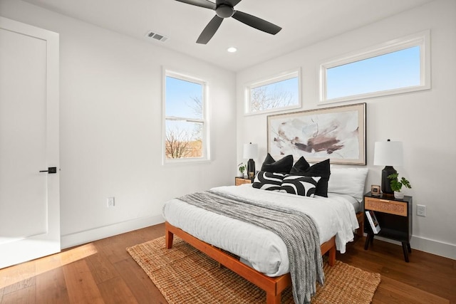 bedroom featuring wood finished floors, baseboards, recessed lighting, and ceiling fan