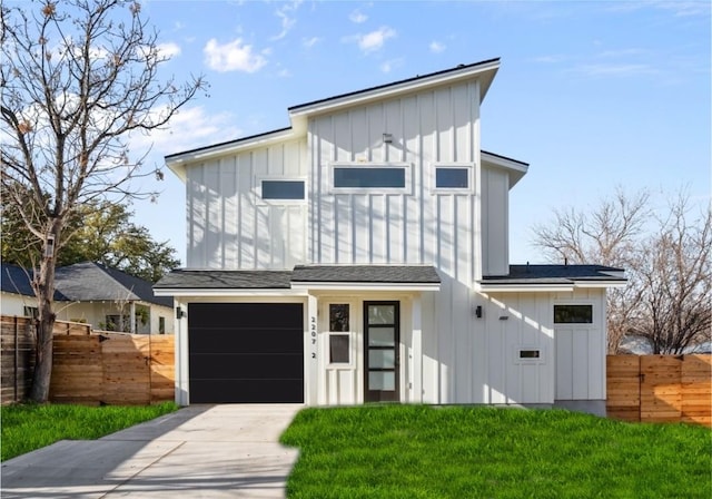 view of front of home with board and batten siding, driveway, a garage, and a shingled roof