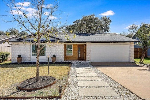 ranch-style house featuring a garage, concrete driveway, fence, a front lawn, and brick siding