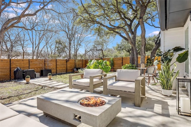 view of patio / terrace featuring a fenced backyard and an outdoor living space with a fire pit