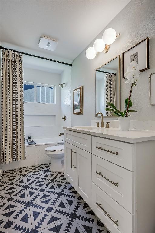 bathroom featuring shower / washtub combination, vanity, and toilet