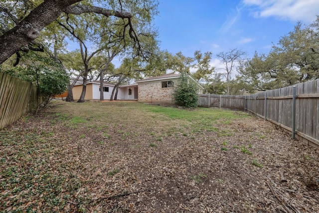 view of yard with a fenced backyard