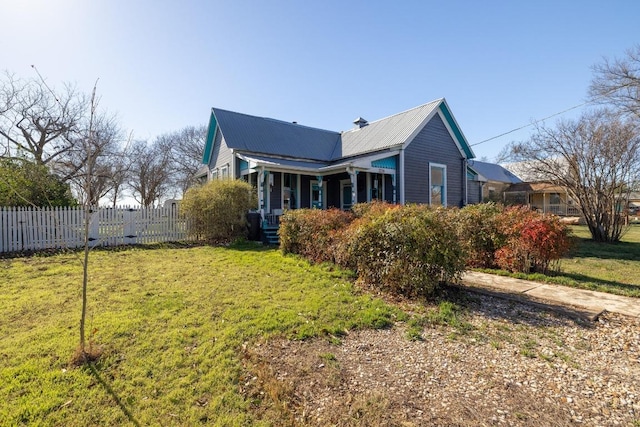 back of house featuring fence and a yard