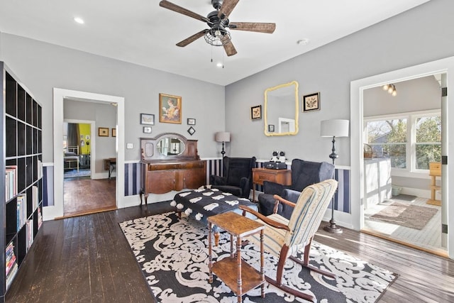 interior space with a ceiling fan, wood-type flooring, and baseboards