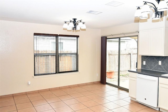 unfurnished dining area featuring a chandelier, light tile patterned flooring, visible vents, and baseboards