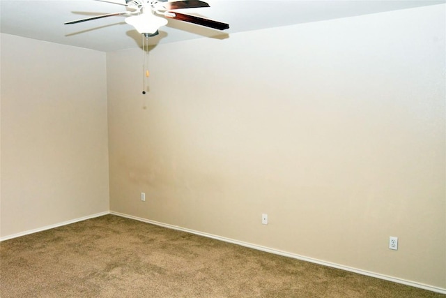 spare room with carpet floors, baseboards, and a ceiling fan