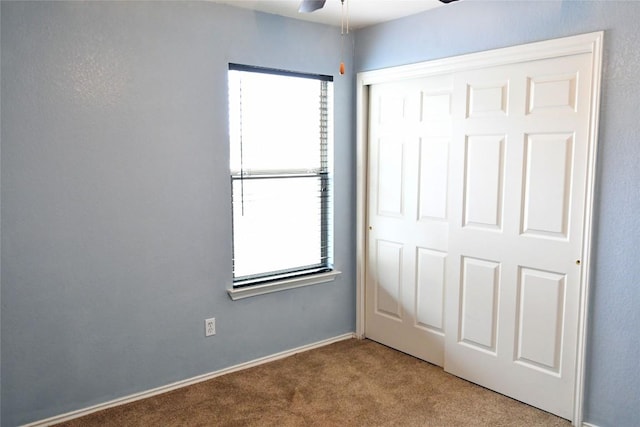 unfurnished bedroom featuring a closet and carpet flooring