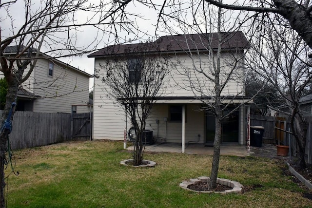 back of property featuring a yard, a patio area, and a fenced backyard