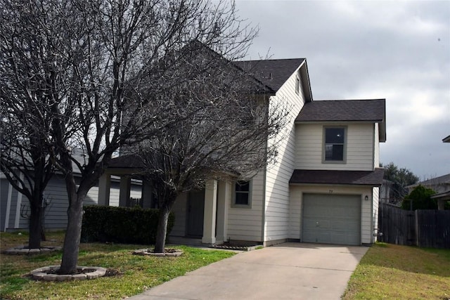 view of front facade featuring an attached garage, fence, a front lawn, and concrete driveway