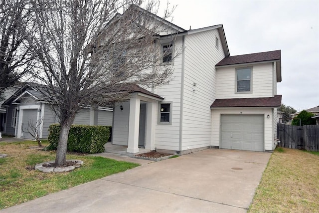 view of front of property featuring a garage, driveway, and fence