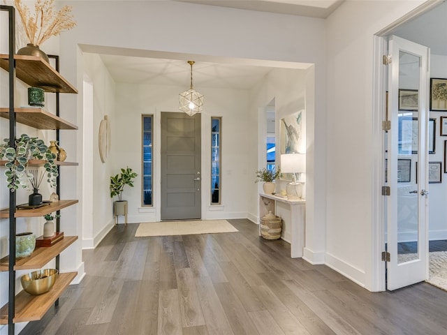 entryway with wood finished floors and baseboards