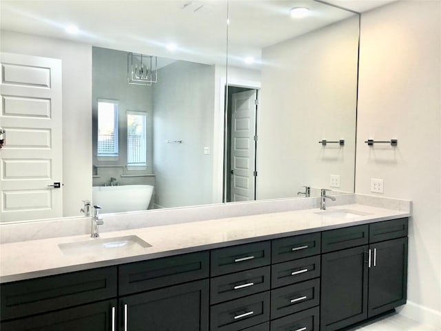 bathroom with double vanity, a soaking tub, and a sink