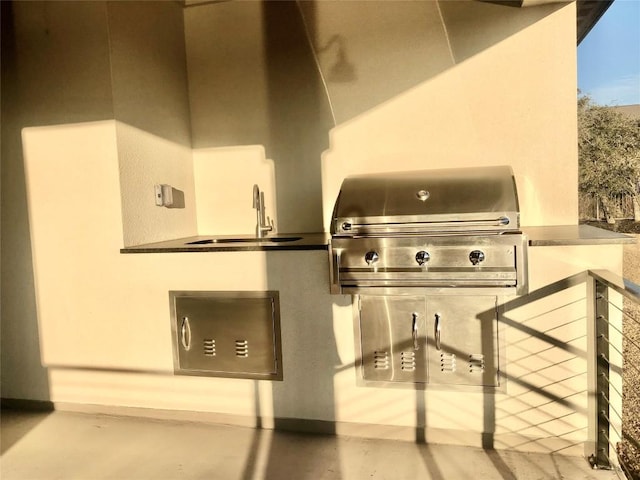 exterior space with a grill, a sink, and area for grilling