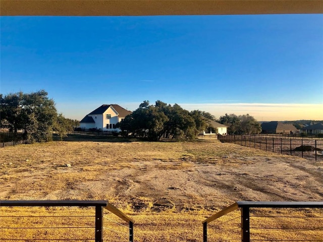 view of yard featuring fence and a rural view