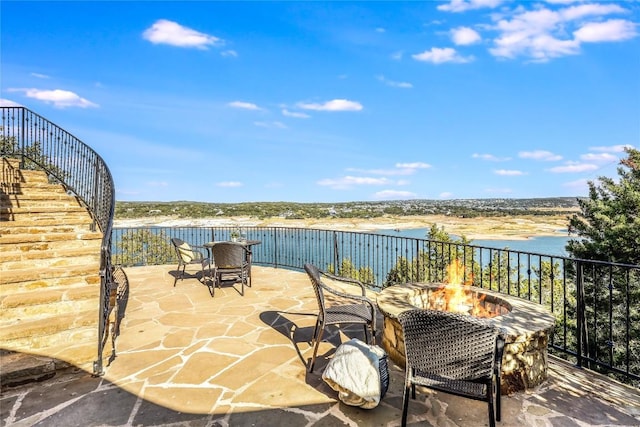 1208 Watercliffe Dr, Lago Vista, TX 78645 - view of patio featuring an outdoor fire pit and a water view