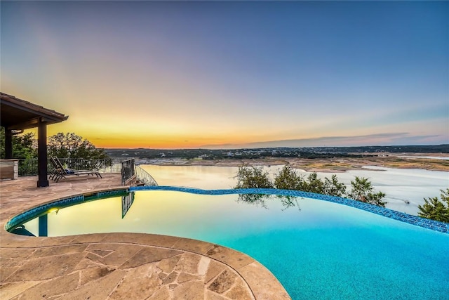 1208 Watercliffe Dr, Lago Vista, TX 78645 - pool at dusk with a patio area and an outdoor pool