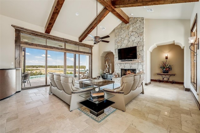 1208 Watercliffe Dr, Lago Vista, TX 78645 - living room featuring high vaulted ceiling, a stone fireplace, baseboards, beam ceiling, and stone tile flooring