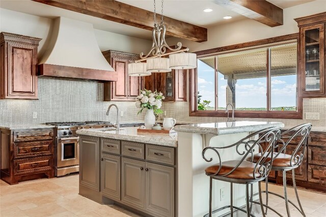 1208 Watercliffe Dr, Lago Vista, TX 78645 - kitchen with light stone counters, beam ceiling, custom range hood, backsplash, and high end stove