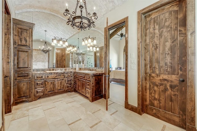 1208 Watercliffe Dr, Lago Vista, TX 78645 - bathroom featuring baseboards, brick ceiling, vaulted ceiling, vanity, and ceiling fan with notable chandelier