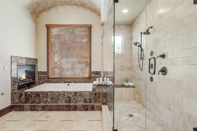 1208 Watercliffe Dr, Lago Vista, TX 78645 - full bathroom with lofted ceiling, a fireplace, a shower stall, and a bath