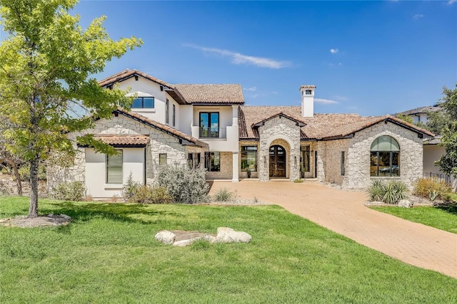 1208 Watercliffe Dr, Lago Vista, TX 78645 - view of front of house featuring a front yard, stone siding, a tiled roof, and stucco siding