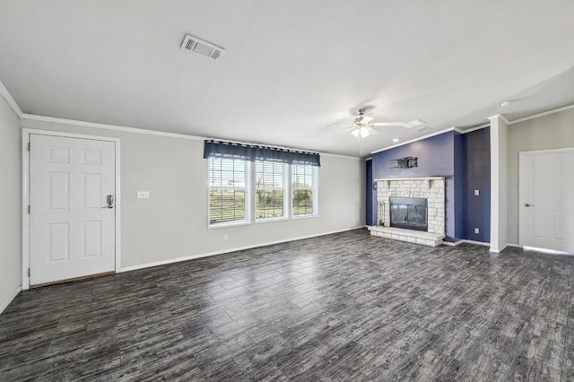 unfurnished living room with visible vents, a glass covered fireplace, ceiling fan, wood finished floors, and crown molding