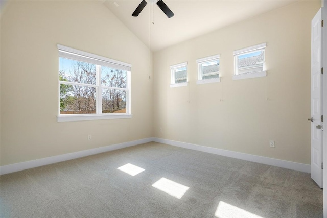 unfurnished room featuring lofted ceiling, baseboards, a ceiling fan, and light colored carpet