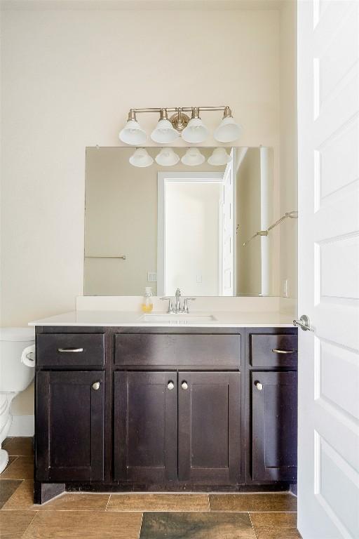 bathroom featuring toilet and vanity