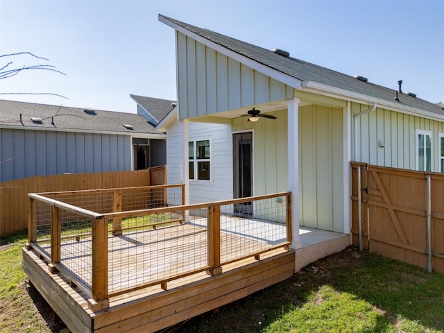 rear view of house with a ceiling fan and board and batten siding