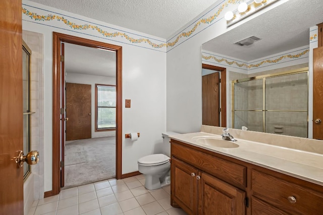 bathroom with a textured ceiling, toilet, vanity, visible vents, and an enclosed shower