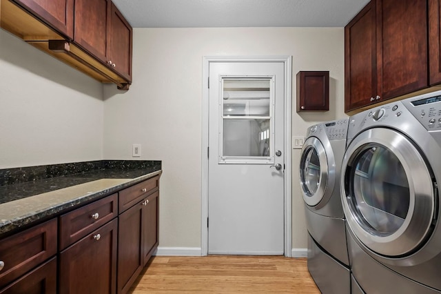 laundry area featuring cabinet space, light wood-style flooring, baseboards, and independent washer and dryer