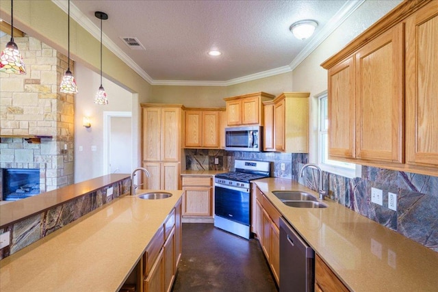 kitchen featuring appliances with stainless steel finishes, a sink, visible vents, and decorative backsplash