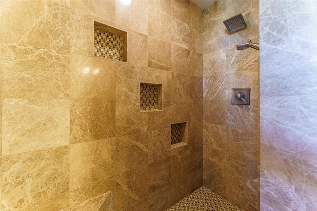 bathroom with tiled shower