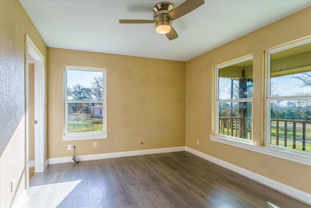 empty room featuring a ceiling fan, baseboards, and wood finished floors