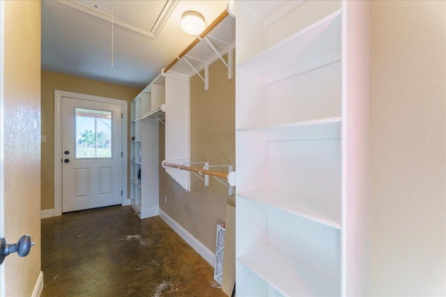 spacious closet featuring attic access